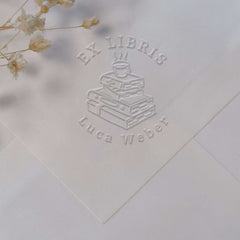 Bookplate embosser, pile of books, coffee
