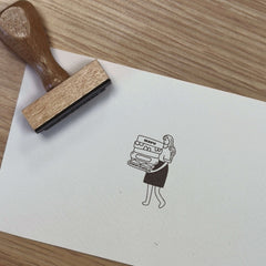 Ex-libris stamp of a woman carrying books