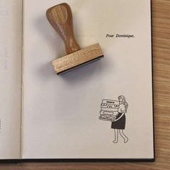 Ex-libris stamp of a woman carrying books