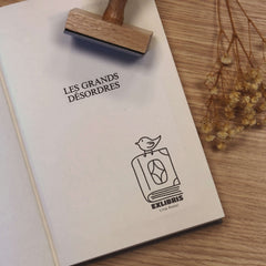 Bookplate of a bird on a book