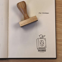 Bookplate of a bird on a book