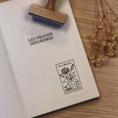 Ex-libris stamp of a flowering plant with a target