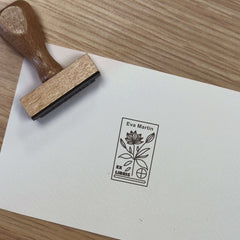 Ex-libris stamp of a flowering plant with a target