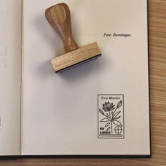 Ex-libris stamp of a flowering plant with a target