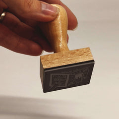 Ex-libris stamp: hands holding a book
